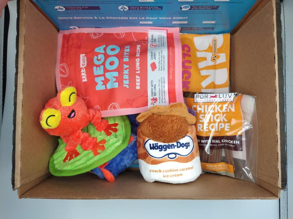 March 2024 BarkBox showing 2 bags of dog treats, 3 dog toys, and bag of chicken sticks